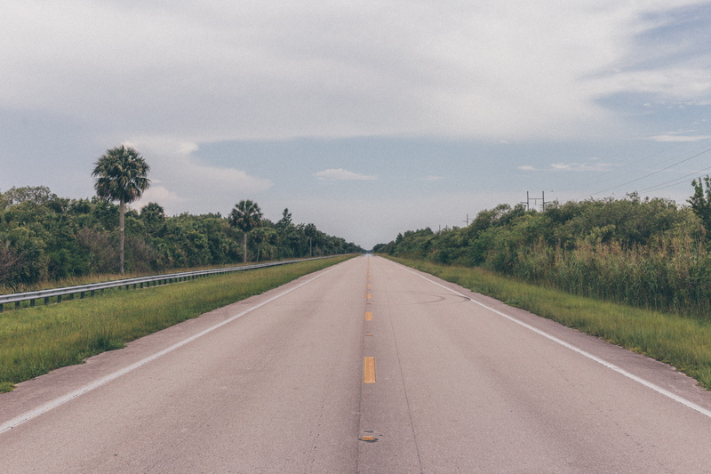land, gray, environment, transportation, highway, diminishing perspective, asphalt, road marking, grass, green, street, beside, direction, outdoors, cloud - sky
