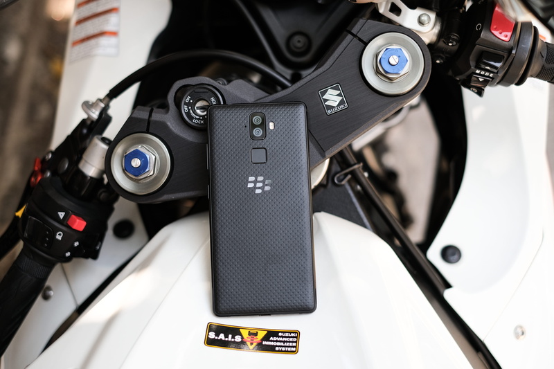 logo, land vehicle, suzuki, no people, phone, still life, spoke, black color, wheel, photographic equipment, blackberry, engine, equipment, motor vehicle