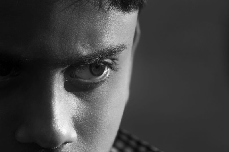 human eye, macro eye, human body part, real people, darkness, males, looking at camera, ground, portrait, black background, spirit, human face, dark, contemplation