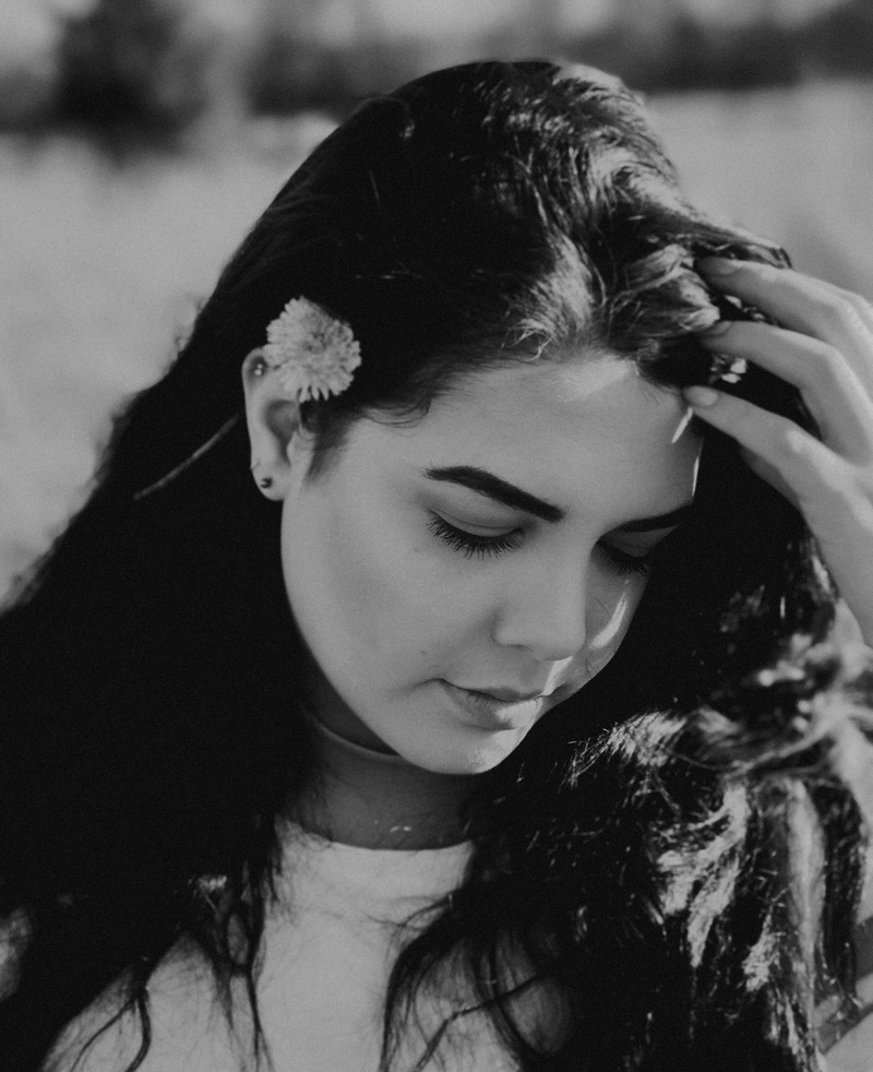 young adult, human hair, touching face, black and white, holding, focus on foreground, real people, long hair, hair, headshot, ear, person, looking, close-up