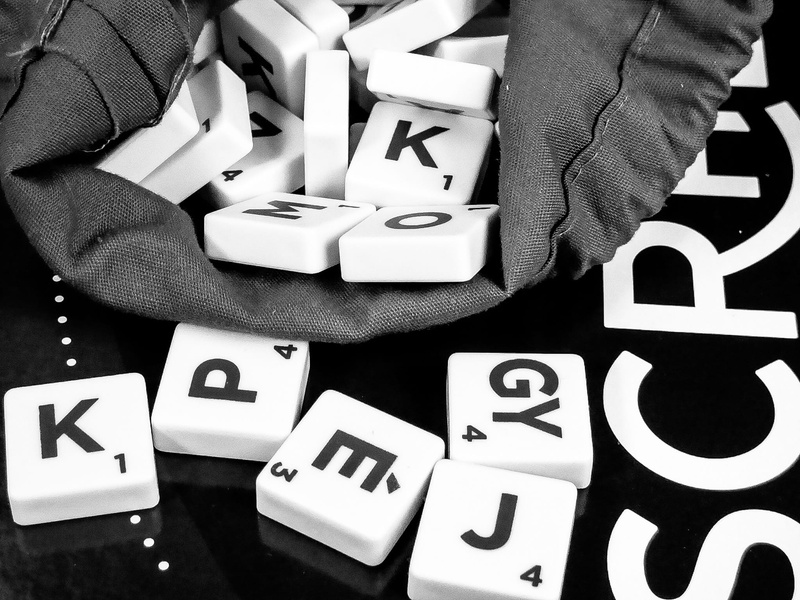 holding, entertainment, real people, number, human hand, conceptual, white color, letter, success, text, western script, capital letter, knowledge, money