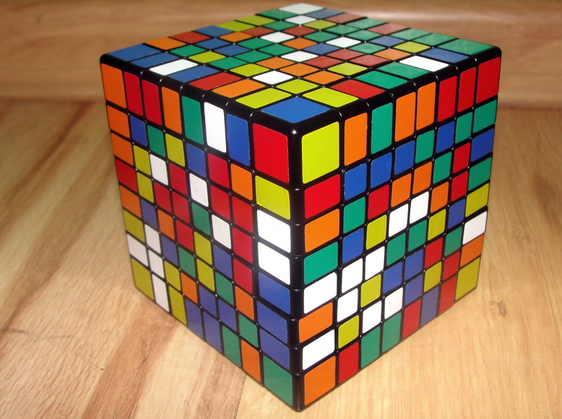 no people, close-up, block, design, 2K, shape, memory, 8x8x8, pattern, indoors, table, rubiks cube, logic, multi colored, cube Shape, focus on foreground