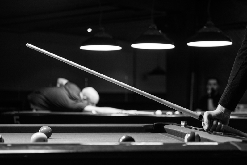 pool - cue sport, pool ball, people, pool hall, pool, sport, leisure activity, game, man, players, cue, blur, holding, black-and-white, lighting equipment