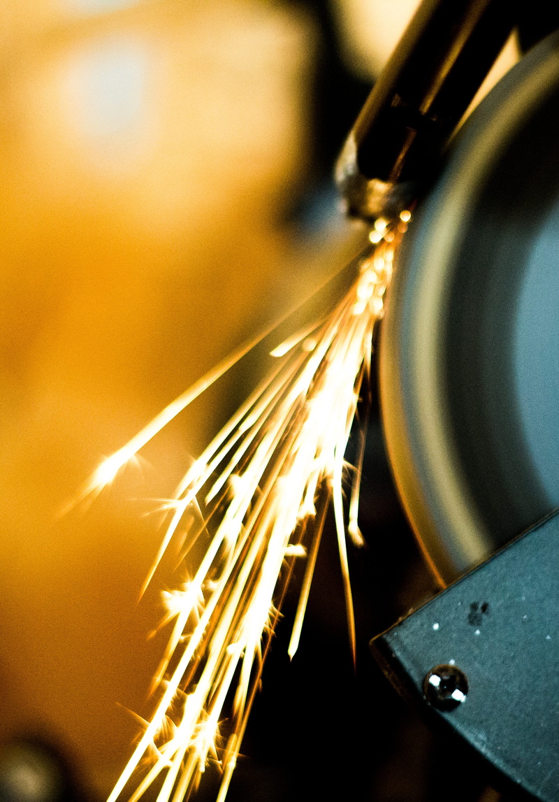 metal, gold colored, machinery, spark, blurred motion, manufacturing equipment, metal industry, precision, focus on foreground, fire, bright, round, indoors