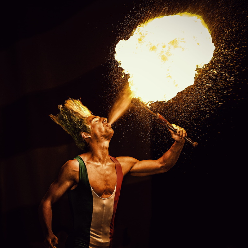 muscular build, fire, athlete, waist up, fire - natural phenomenon, black background, one person, fire blower, man, gas, performance, blowing, skill, blow