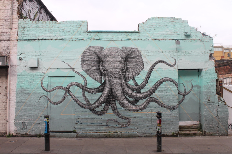 male likeness, built structure, outdoors, UK, wall - building feature, craft, representation, tentacles, artwork, statue, day, sculpture, elephant, architecture