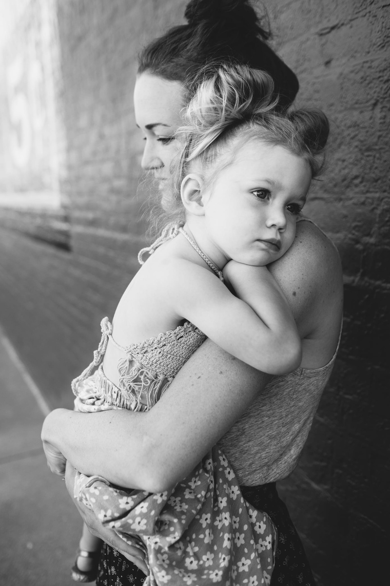 outdoors, men, grayscale, smiling, family with one child, wall, women, people, family, black And White, childhood, kid, carrier, child, mother, lifestyle