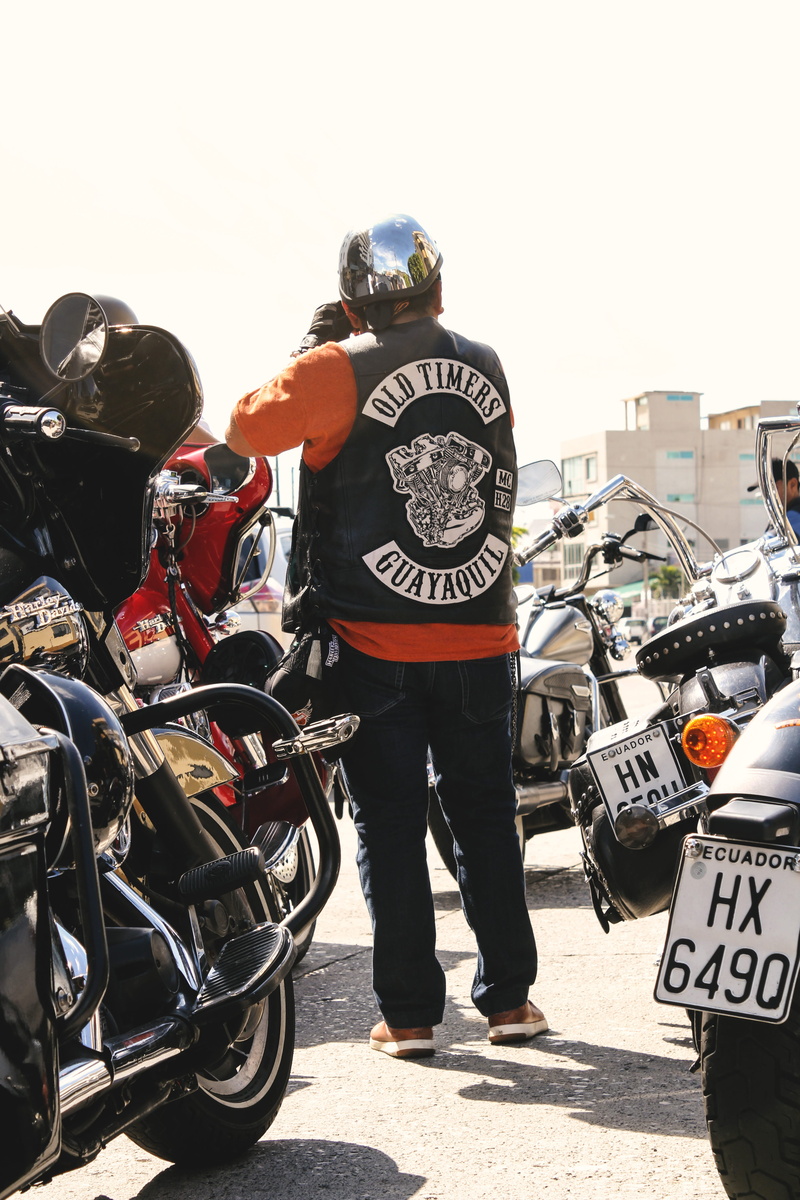 people, man, plate number, clear sky, crash helmet, casual clothing, transportation, text, mode of transportation, action, club, day, motor vehicle, motorcycles