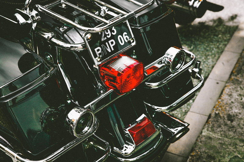 focus on foreground, transportation system, wheel, focus, text, high angle view, tail lights, metal, license plate, silver, number, motorcycle, close-up