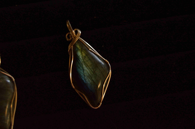 positive emotion, focus on foreground, craft, black background, stone, close-up, precious gem, 5K, love, setting, jewelry, hanging, day, wealth, metal