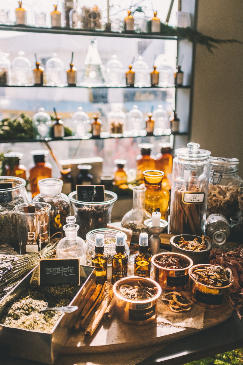 glass, confectionery, sweets, focus on foreground, beverage, food, lot, no people, perfume, cosmetics, assorted, indoors, container, shop, bar counter