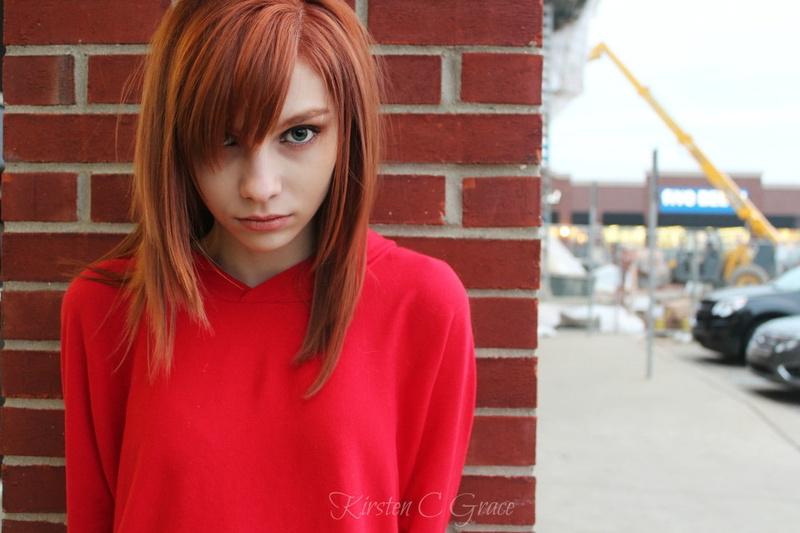 real people, redhead, portrait, young adult, hairstyle, day, red, looking at camera, leisure activity, casual clothing, beautiful woman, women, brick, one person