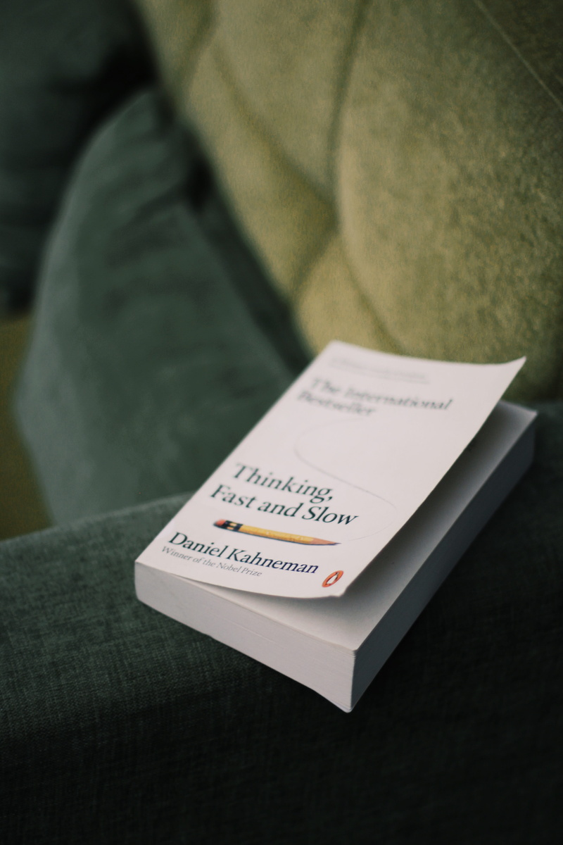business card, text, person, holding, brochure, diary, still life, reading, close-up, human, focus on foreground, page, psychology, book, western script