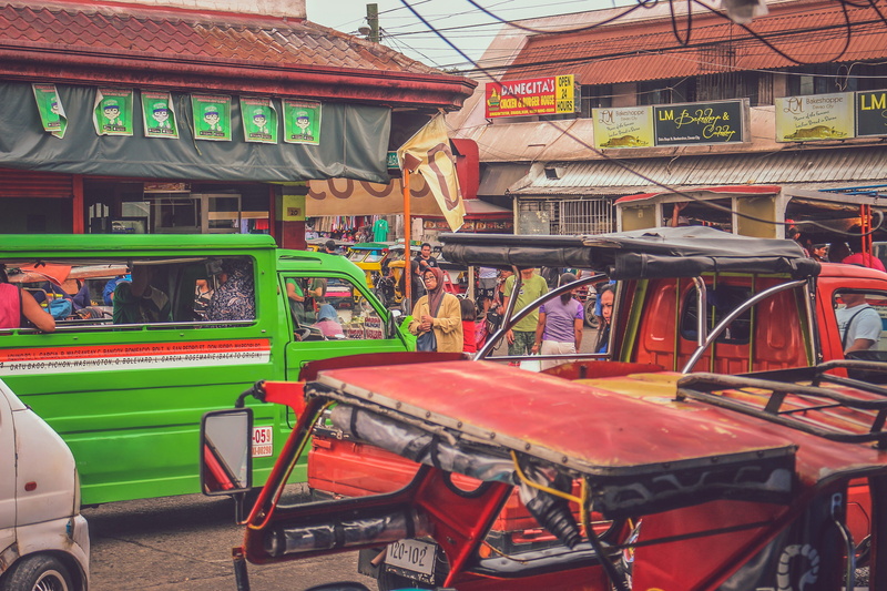 vehicles, land vehicle, coupe, human, shop, cafe, sports car, public transportation, tire, middle, building, market, automobile, brick, transportation