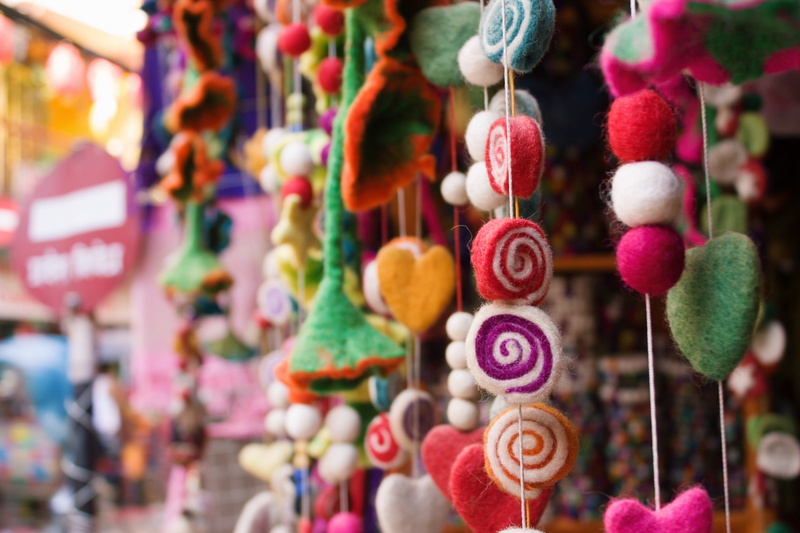 ornament, close-up, daytime, traffic sign, colorful, stall, retail display, retail, threads, no people, bright, street, hanging, large group of objects