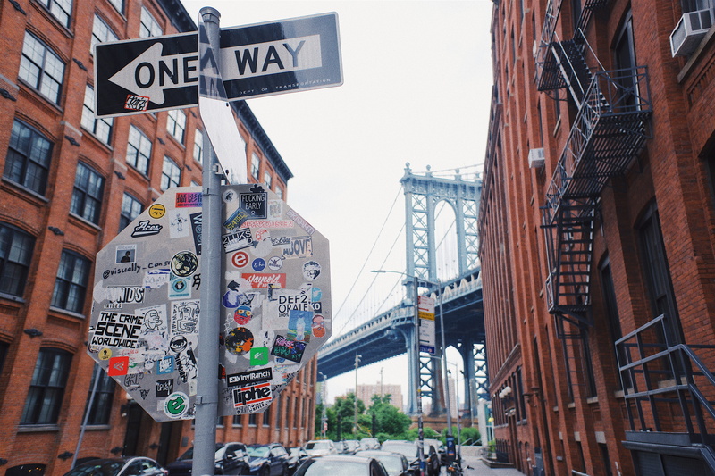 information, no people, one way, communication, road sign, western script, nyc, road, manhatten, script, buildings, building exterior, day, sign, non-western script