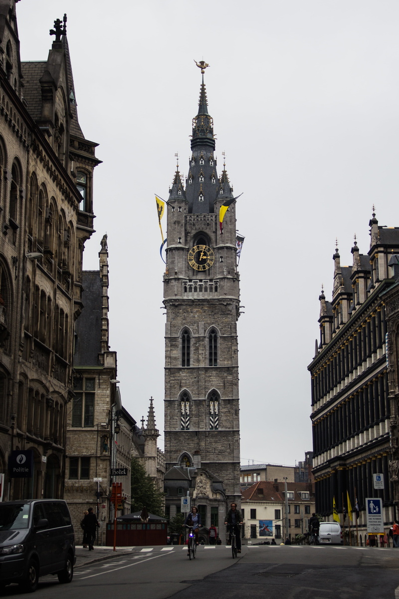 flags, church tower, car, city, outdoors, sky, belgium, clock, building, tower, travel destinations, place of worship, mode of transportation, belfry tower