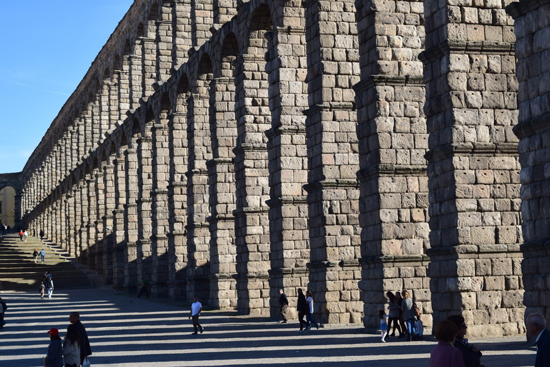 real people, segovia, walking, built structure, travel destinations, shadows, structure, city, historical, building, building exterior, roman, spain, symmetrical