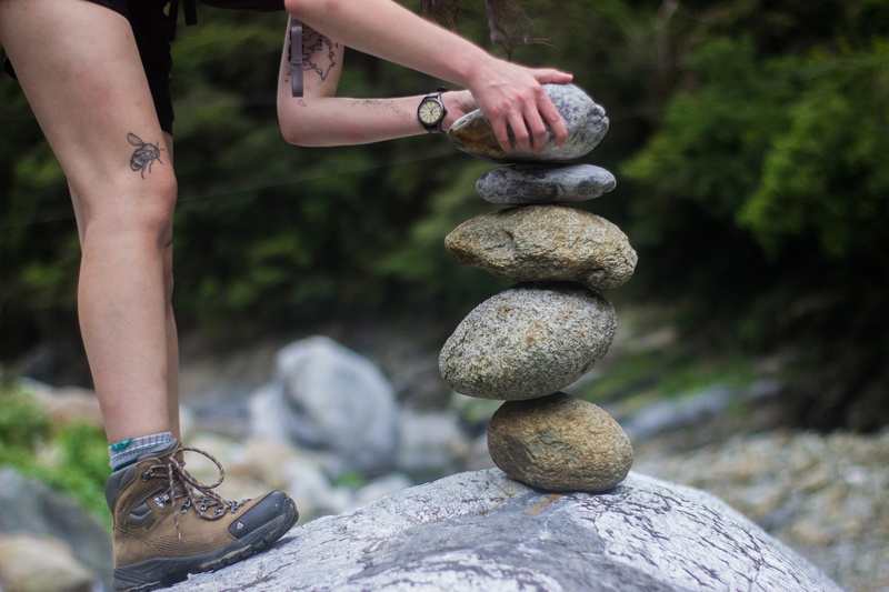 travel, stone - object, pebble, rock - object, lifestyles, adventure, women, leisure activity, real people, legs, focus on foreground, shoe, balance, one person