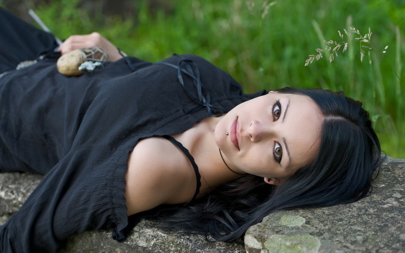 black dress, hair, beauty, young adult, dark hair, sleeved, black, leisure activity, beautiful woman, relaxation, lying down, portrait, piercing, outdoors