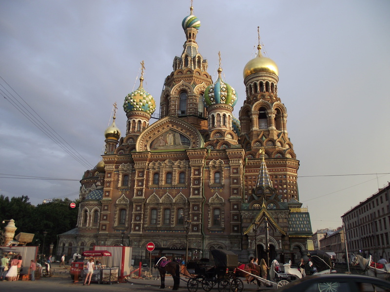 tourism, savior on blood, building exterior, religion, belief, city, crowd, spirituality, built structure, travel destinations, large group of people, cloud - sky
