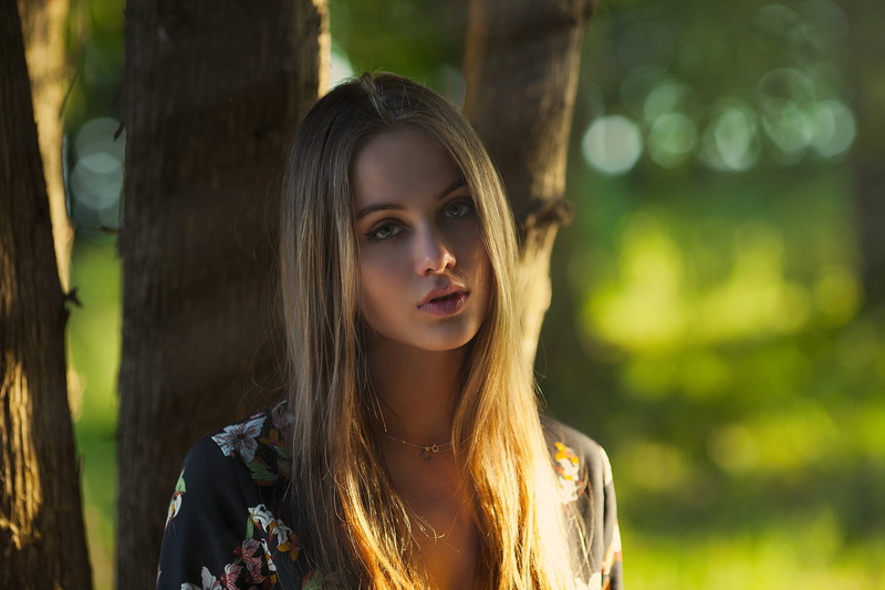 1080P, black, headshot, blonde, bokeh, real people, portrait, floral, plant, top, beautiful woman, necklace, focus on foreground, long hair, young adult