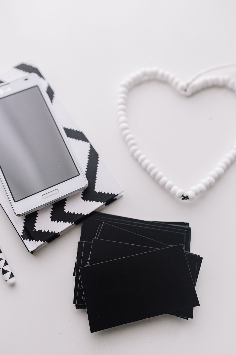 technology, heart shape, pencils, smartphone, various, no people, love, black, cup of coffee, table, items, still life, studio shot, jewelry, telephone