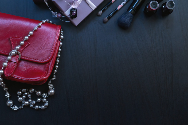 table, leather, cosmetics, close-up, black background, necklace, 5K, fashion, handbag, no people, zipper, high angle view, elegance, clothing, girls, copy space