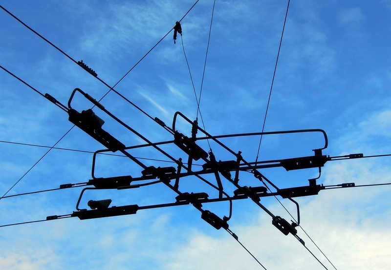 no people, electricity pylon, low angle view, cable, engineering, civilization, blue, outdoors, fuel and power generation, sky, trolley, power line, voltage