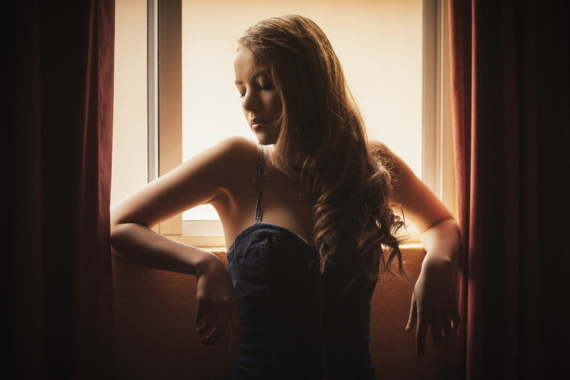 window, dress, brunette, casual clothing, real people, lifestyles, bare shoulders, face, closed eyes, young women, beauty, leisure activity, women, contemplation