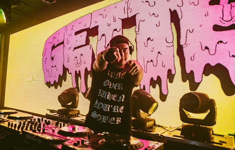concert, technology, getter, performer, indoors, canada, waist up, one person, graffiti, lights, night life, man, front view, shirt, clothing, venue, occupation