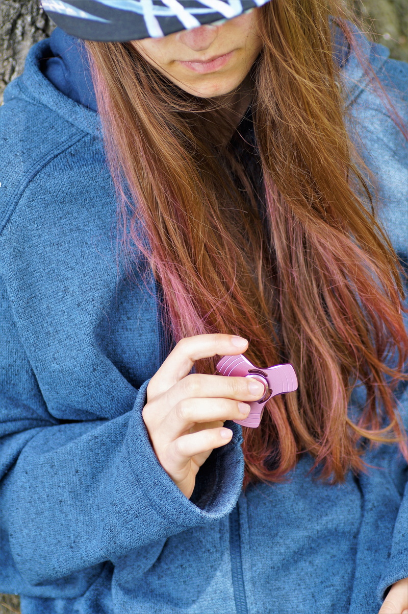 caucasian Ethnicity, Girl, Fidget, lifestyles, long hair, women, wireless technology, metal spinner, casual clothing, Toy, propeller above the, young women
