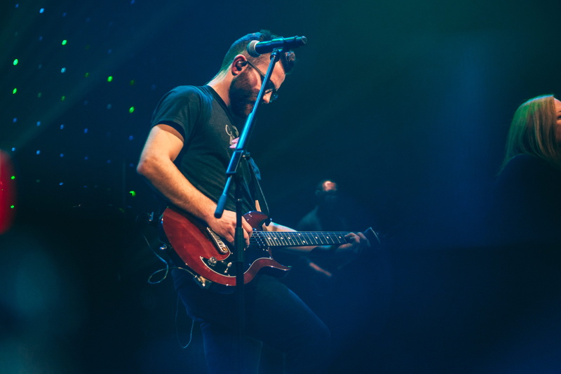 microphone, artist, stage - performance space, lighting, promontory, guitarist, man, skill, electrical device, church, performance, worship, rock concert