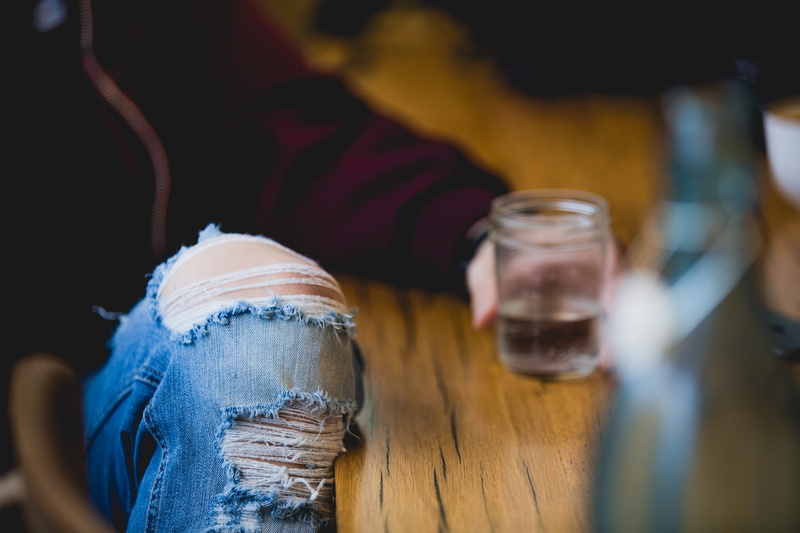 holding, no people, drinking, relaxation, food and drink, lens, human leg, jeans, women, sitting, shift, day, selective focus, lifestyles, close-up, glass