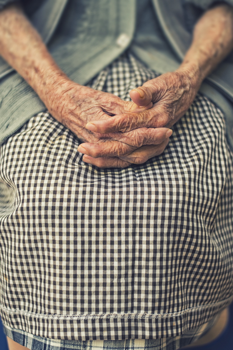 one person, resting, woman, human hand, indoors, senior adult, high angle view, fingers, real people, midsection, prayer, day, folded, aged, age, checkered