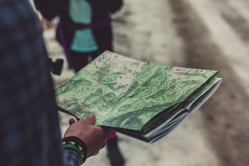wear, outdoors, map, close-up, direction, travelling, people, midsection, focus on foreground, nature, folded, colors, day, green color, landscape, route