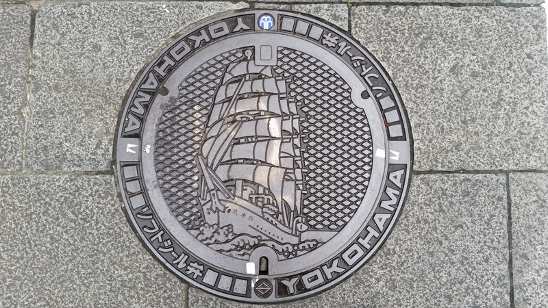 hatch, high angle view, architecture, drain, flooring, design, built structure, pavement, outdoors, lid, ornate, city, day, close-up, pattern, geometric shape