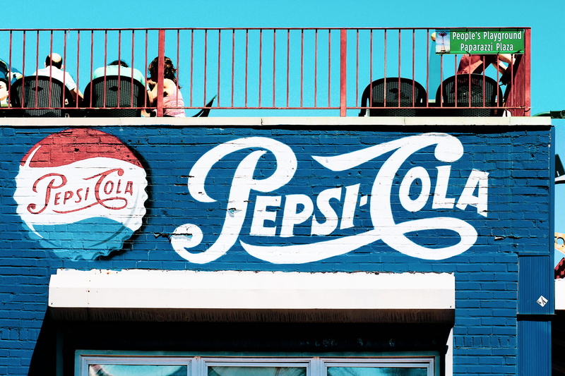 number, architecture, outdoors, leisure activities, food, communication, soda, script, meal, western script, building, pepsi, balcony, sky, cola, mural