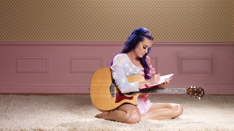 sitting, casual clothing, musical equipment, flooring, string instrument, leisure activity, clothing, one person, playing, hairstyle, music, sitting on floor
