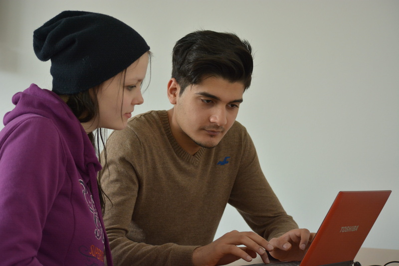 concentration, clothing, computer, studying, teenager, couple - relationship, sitting, connection, wireless technology, assistance, casual clothing, technology