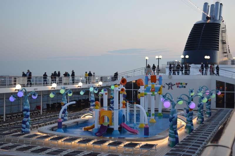 clear sky, architecture, pool deck, water, travel destinations, built structure, day, real people, railing, outdoors, cruise ship, cruise, group of people
