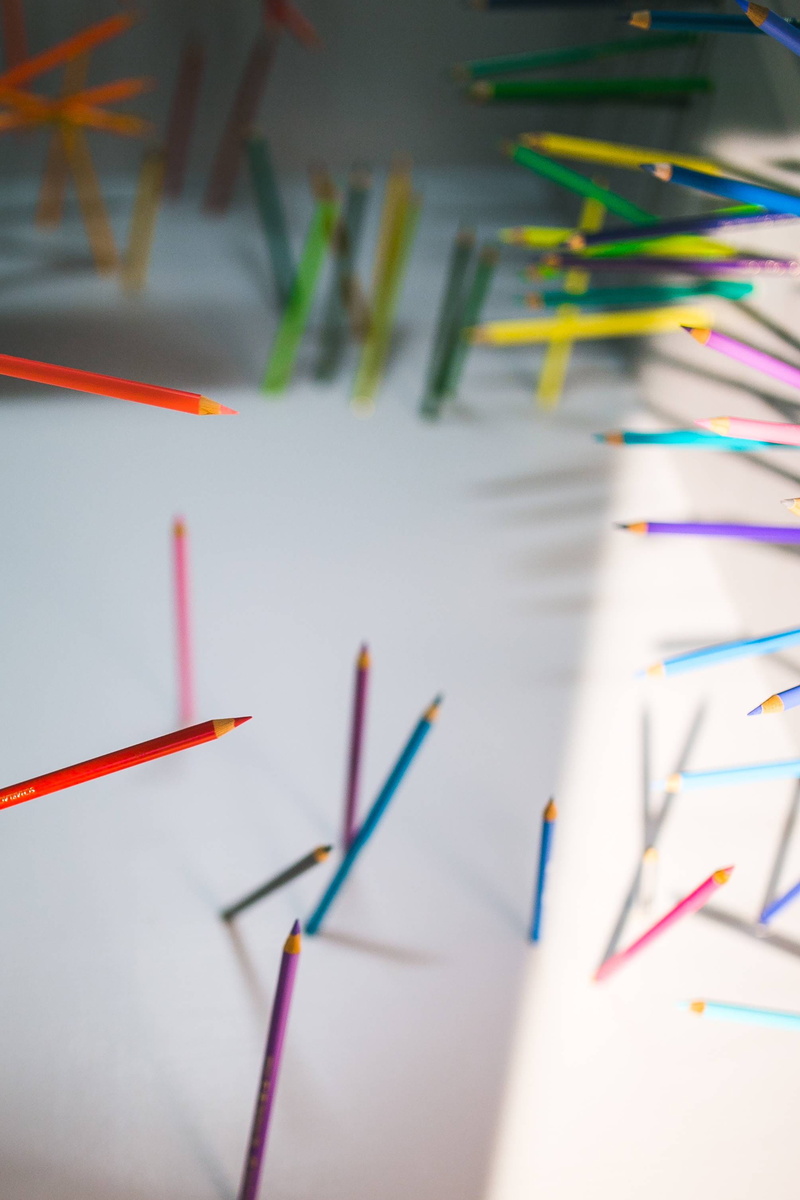 high angle view, indoors, still life, walls, drawing, art and craft, abundance, crayons, colored pencil, day, sticking, selective focus, pencil, large group of objects