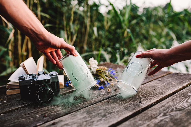 smoke bomb, human body part, one Person, shoe, body part, day, selective focus, wooden desk, nature, human limb, 4K, outdoor, lifestyles, copy Space, focus on foreground