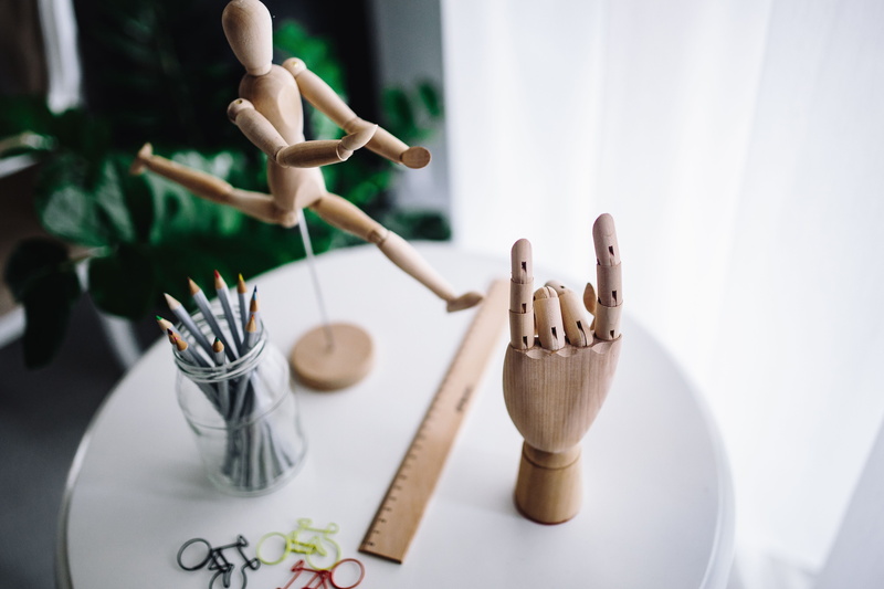 focus on foreground, yarn, table, gesture, pencils, creativity, indoors, model, doll, art and craft, no people, craft, representation, kitchen utensil