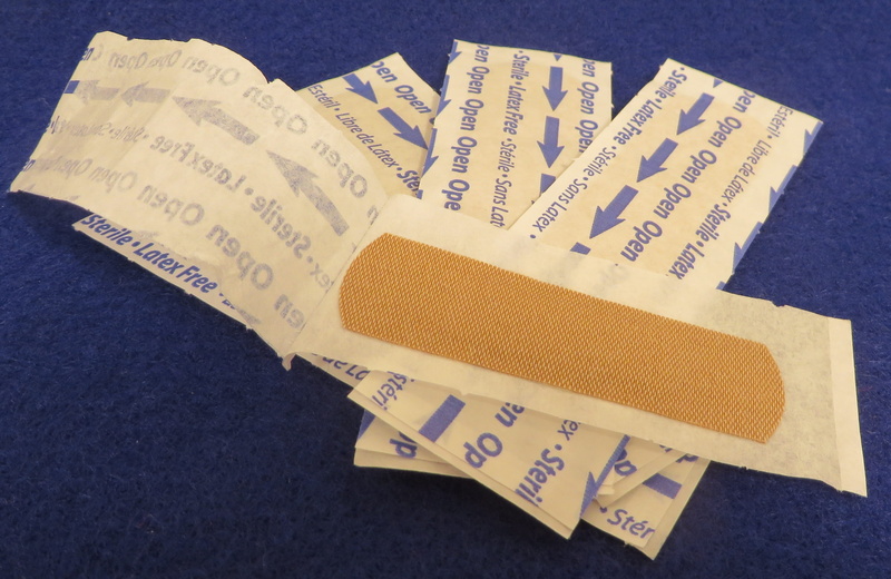 western script, still life, pile, table, textile, non-western script, communication, indoors, text, close-up, band aid, aids, arts culture and entertainment
