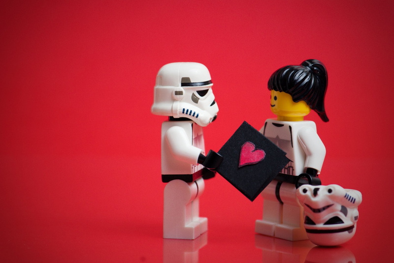 indoors, female likeness, toy, red background, Stormtrooper, plastic, cyborg, minifigures, close-up, colored background, futuristic, human representation