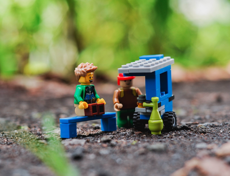 human representation, bricks, outdoors, childhood, close-up, multi colored, figures, mini, toy, field, land, toy car, small, male, robot, enjoying, building