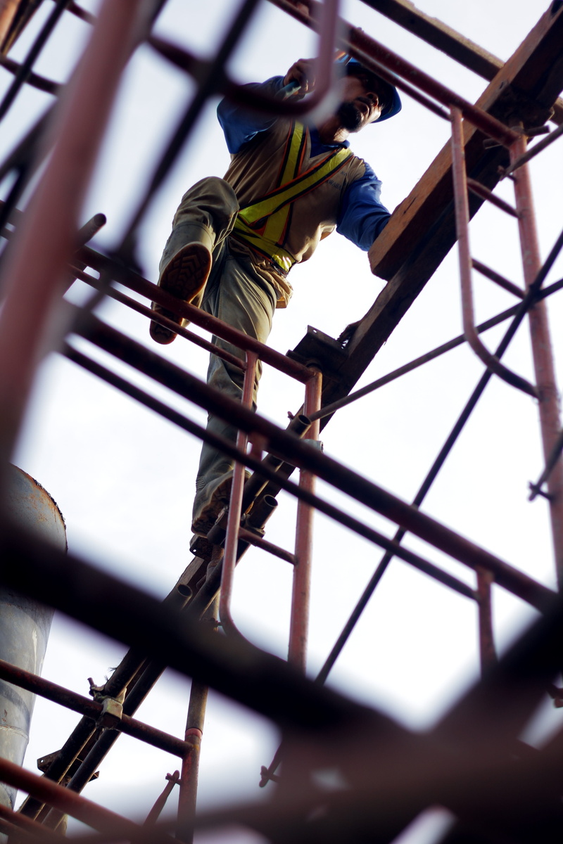 sky, equipment, protection, real people, construction Industry, skill, occupation, low angle view, full length, manual Worker, people, work, risk, construction