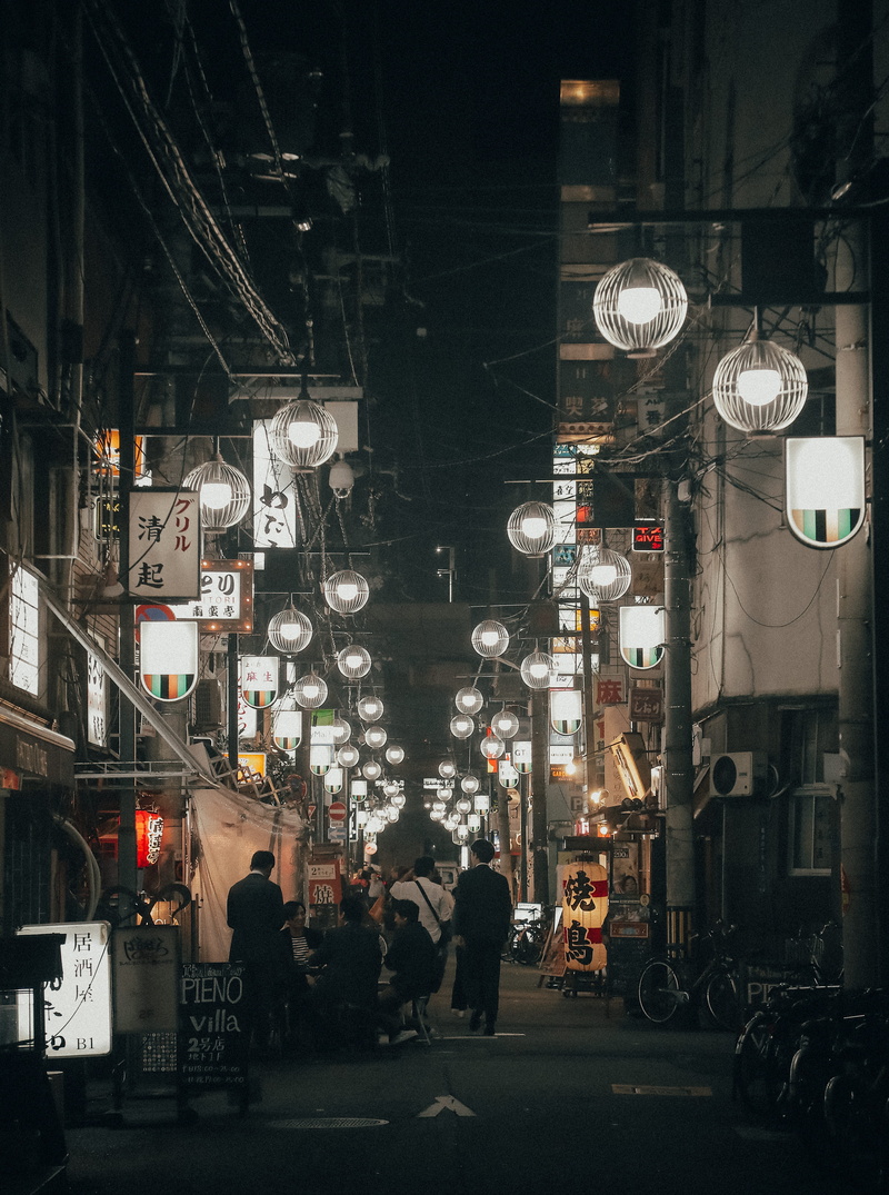 light, men, mode of transportation, night, lifestyles, betweein, clock, people, built structure, lighting equipment, cityscape, market, travel, group of people