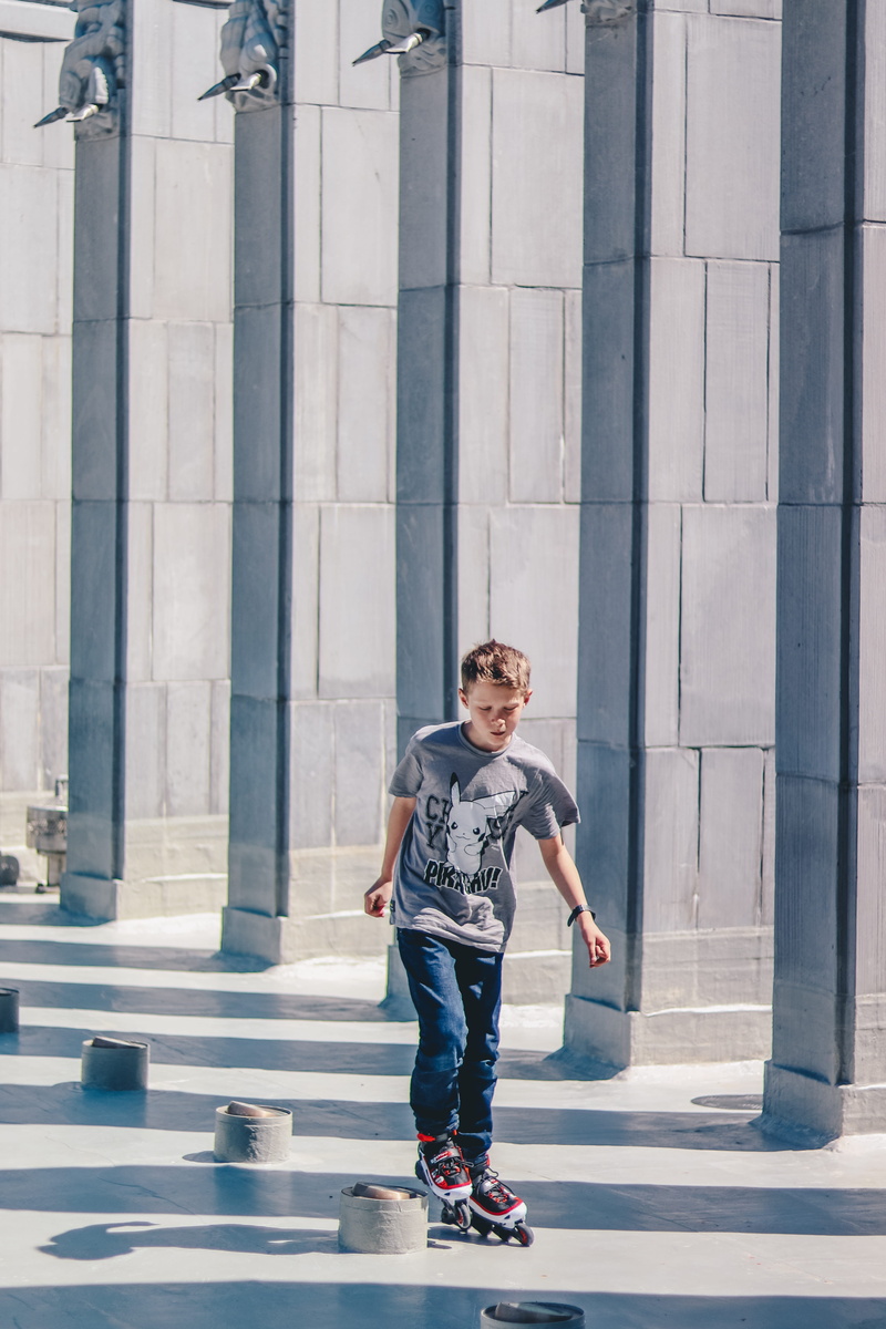 full length, inline, men, built structure, floor, pokemon, pikachu, males, play, childhood, hallway, fun, outdoors, using, child, building, sun, casual clothing